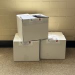 Pro Tapes employees put together three large boxes filled with donated school supplies for the annual Back to School drive.